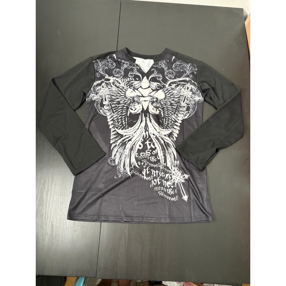 Long sleeve tunic decorative with cross and wings.